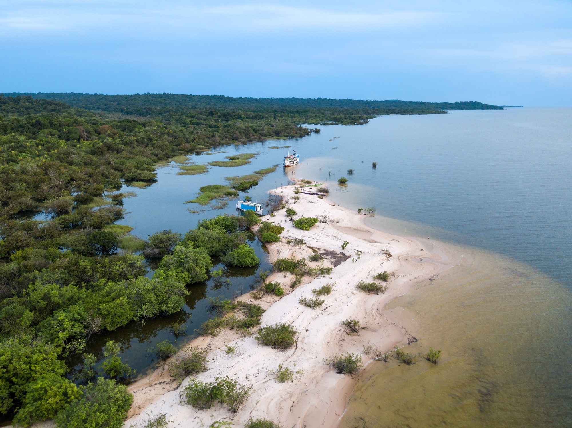 Beautiful drone aerial view of forest trees and beach at Tapajos river beach in Amazon, Brazil.