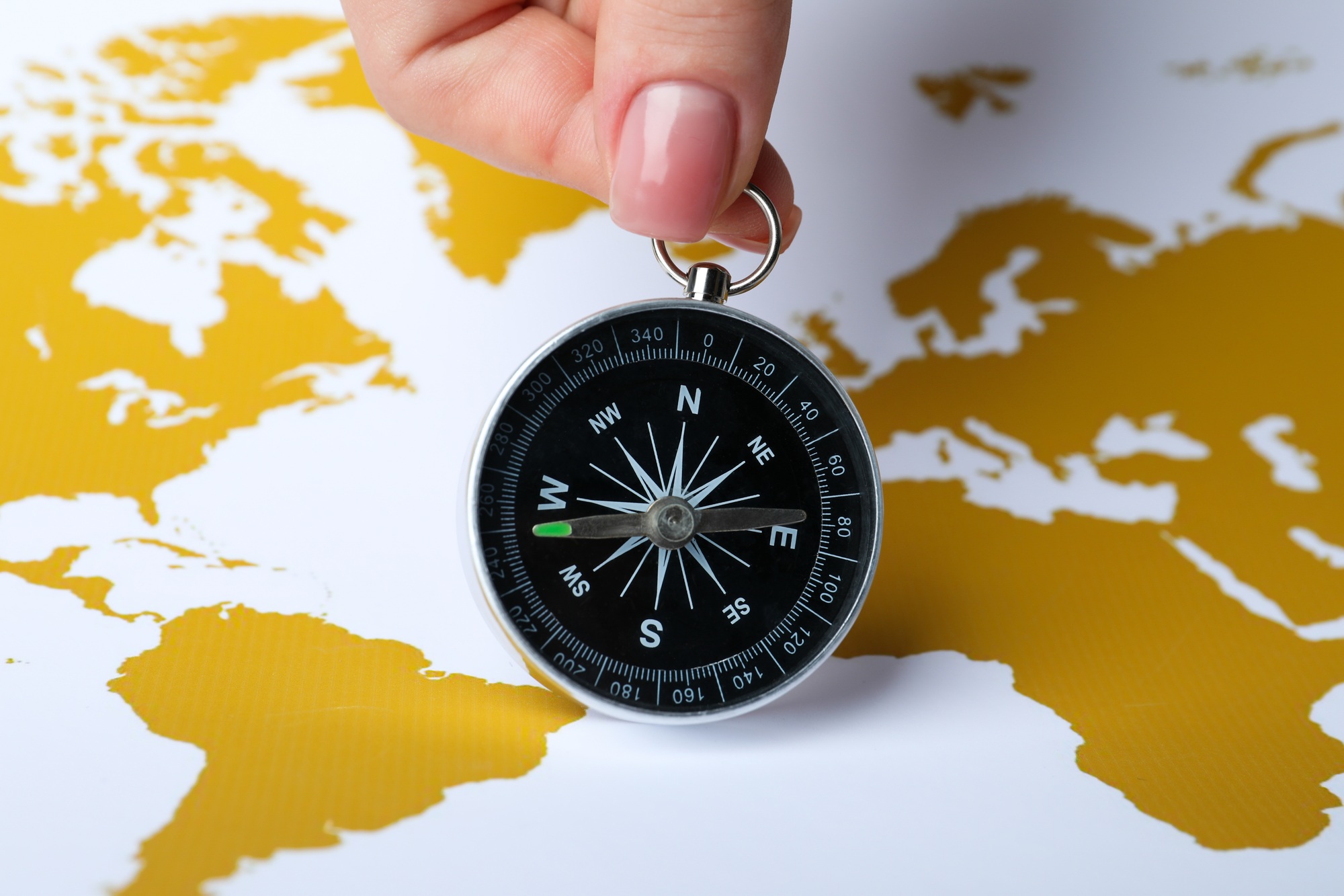 Compass on the background of the world map.