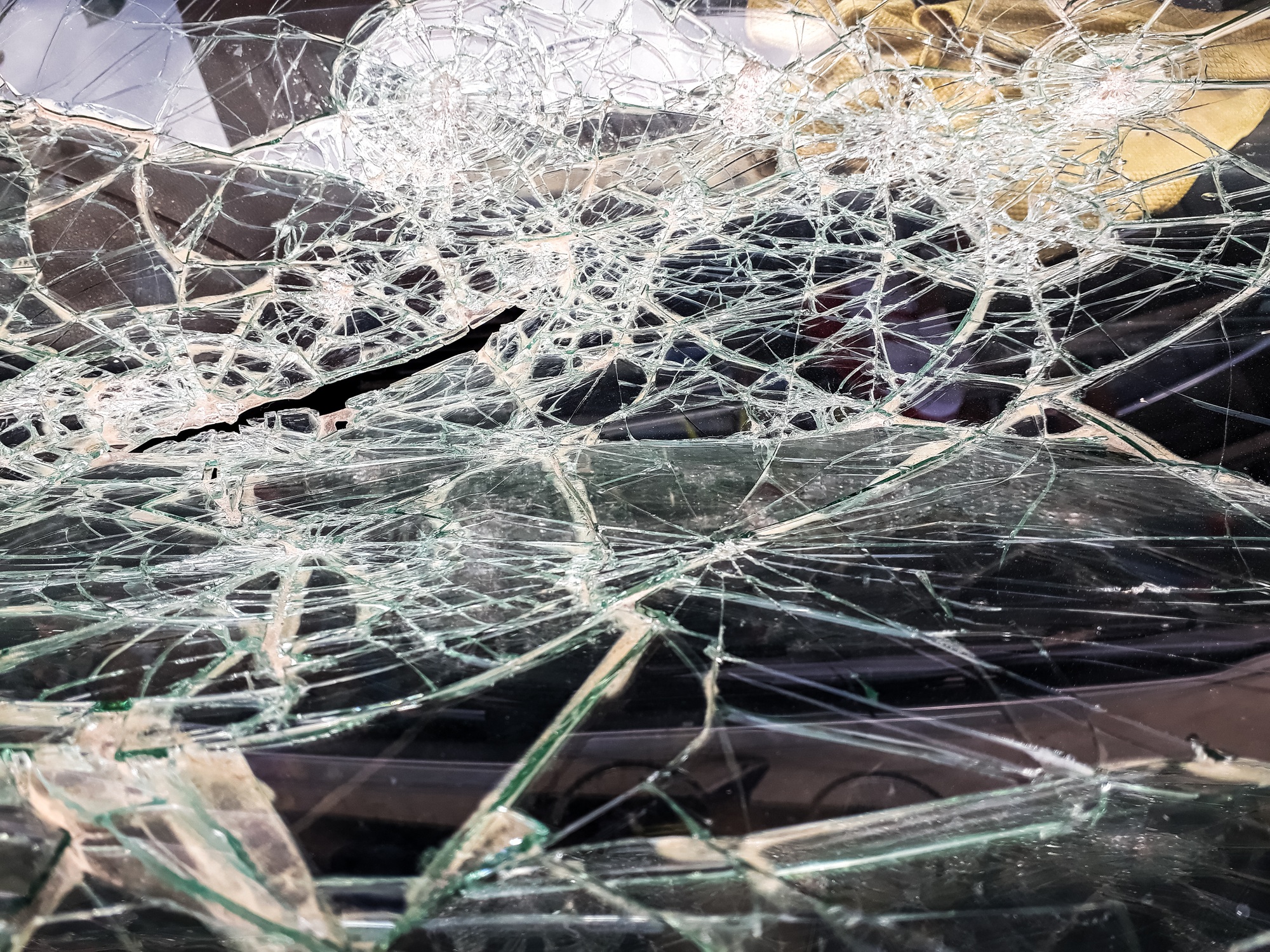 Car windshield shattered with stones by vandals.