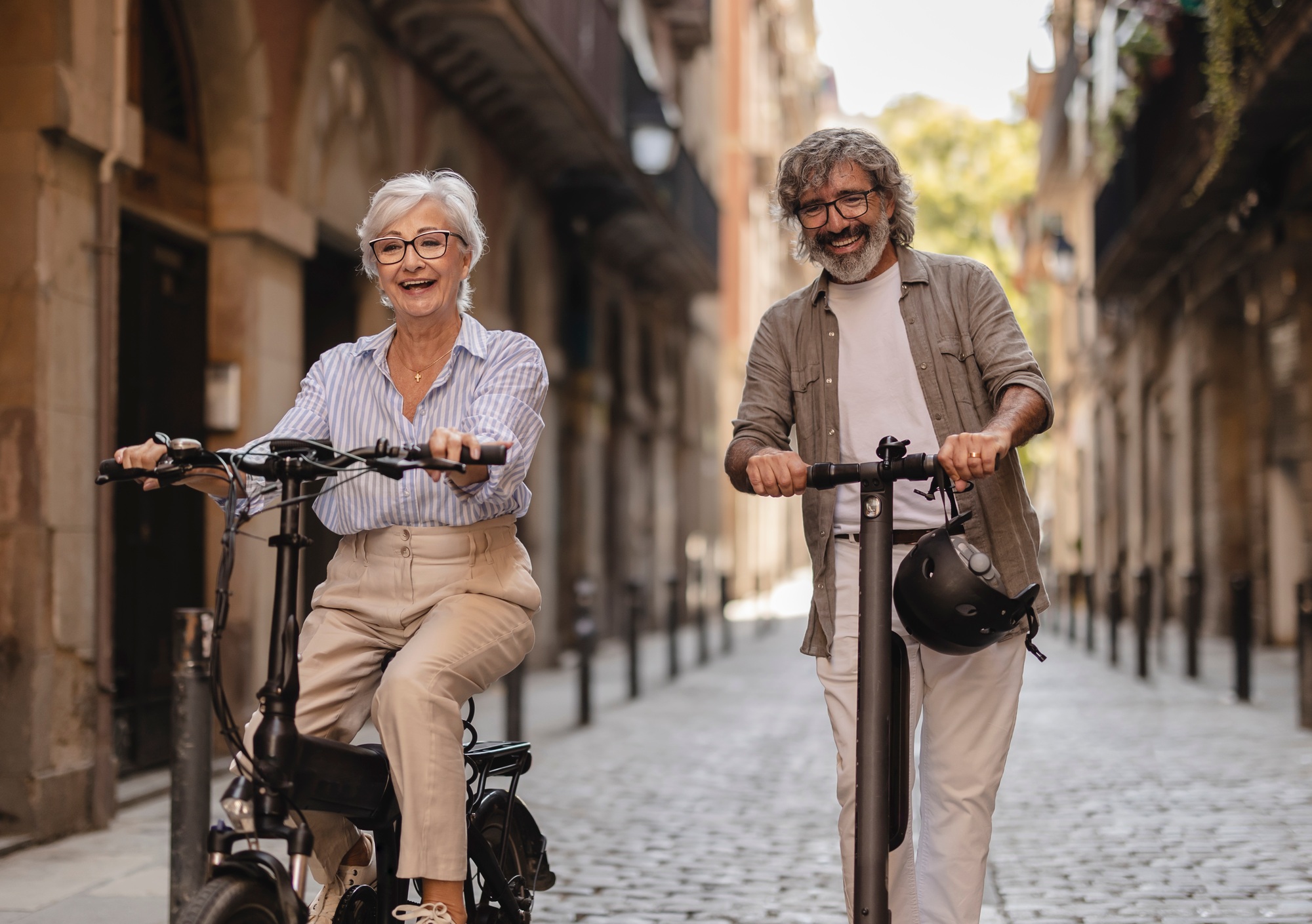 Older couple having fun riding through the city streets